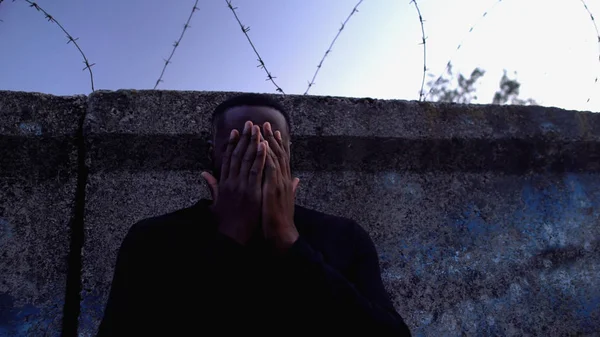 Depressed Afro American Man Standing Barbed Wire Fence Regretting Crime — 스톡 사진