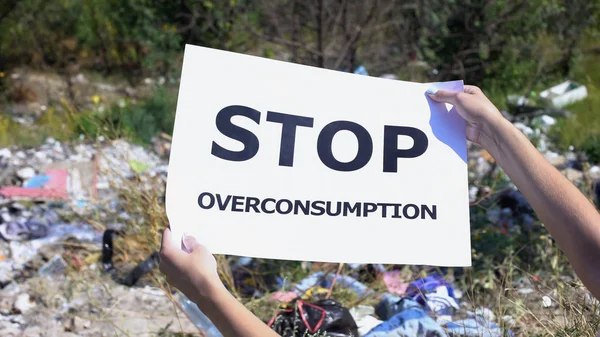 Stop Overconsumption Phrase Cardboard Hands Landfill Background Stock Image