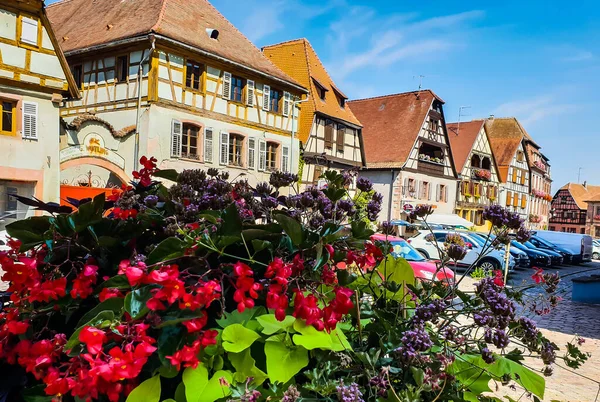 An old stylish village with flowers in the front and blue sky in background