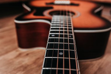 element of a beautiful new clean guitar, six-stringed musical instrument mahogany guitar, metal strings close-up clipart