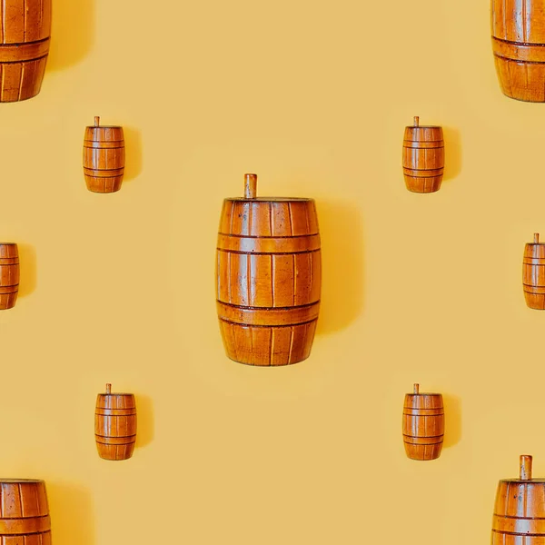 Seamless smooth background for texture and fill. Wooden old vintage orange barrel with a lid on a smooth clean yellow background. Barrels holiday fastelavn