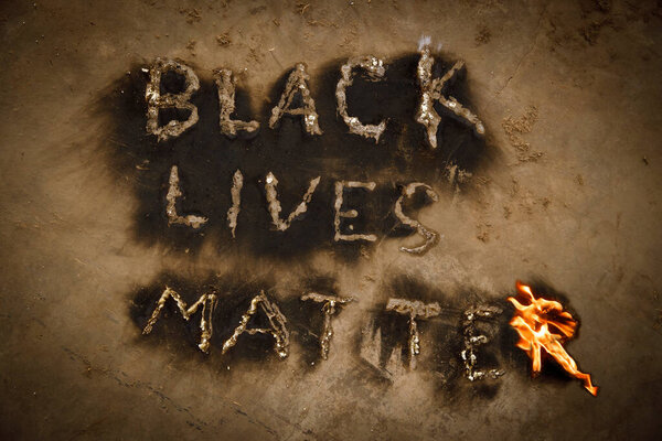 Black Lives Matter text slogan fire flames, human rights protest message revealed by black powdered soot from flaming letters, black lives matter worldwide movement, end racism concept, black history, end racial violence against African Americans