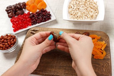 Kız ona kahvaltı hazırlıyor. Kız onun tarihi meyve yulaf lapası bir kesme tahtası üzerinde temizler. Yararlı ve sağlıklı bir kahvaltı. açık renkli.