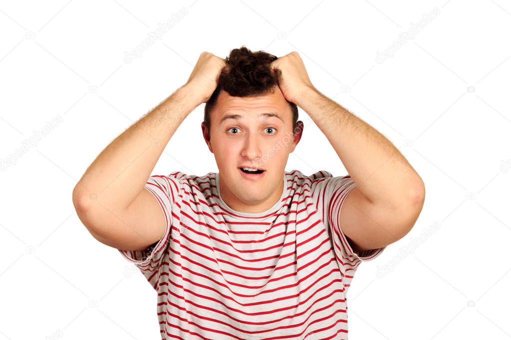 Portrait of a confused bearded man holding hands on his head. emotional guy isolated on white background.