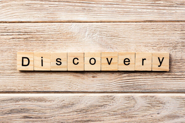 discovery word written on wood block. discovery text on table, concept.