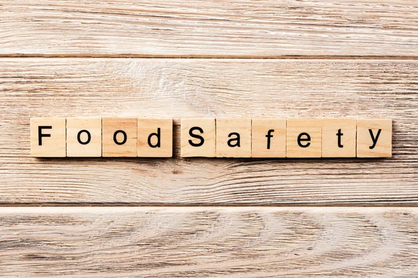 food safety word written on wood block. food safety text on table, concept.