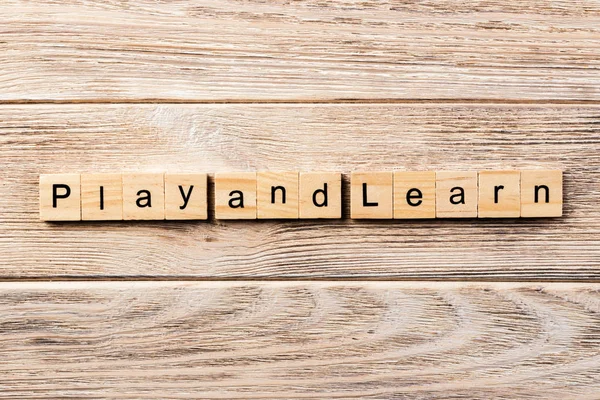 play and learn word written on wood block. play and learn text on table, concept.