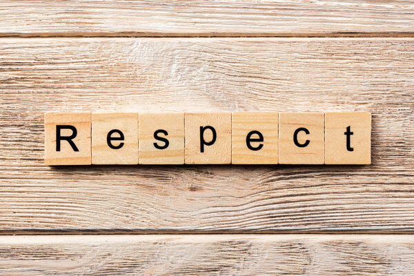 respect word written on wood block. respect text on table, concept.