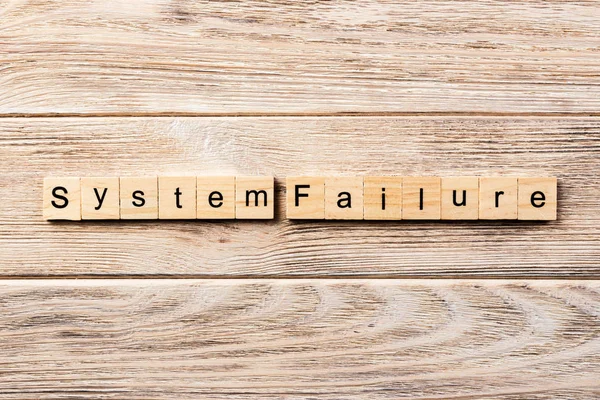 system failure word written on wood block. system failure text on table, concept.