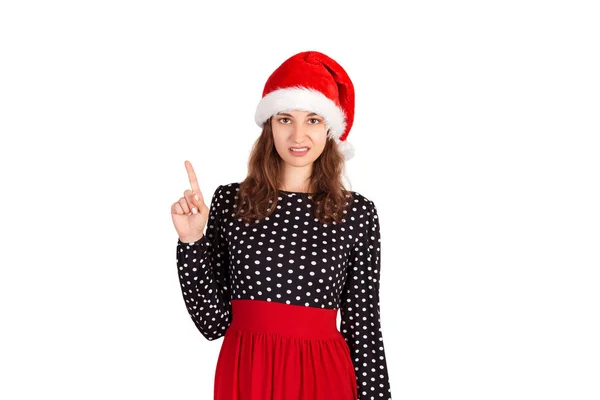 有吸引力的女人的肖像指向食指 在圣诞老人圣诞节帽子查出的情感女孩在白色背景 假日概念 — 图库照片