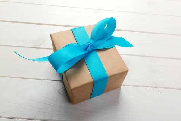 Recycled Paper Gift Box Blue Ribbon Old Wooden White Background Stock Image