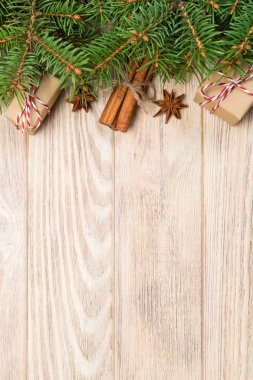 Noel köknar ağacı ve hediye kutusu ahşap masa üzerinde arka plan. Tasarımınız için kopya alanı ile üstten görünüm.
