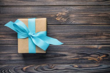 kağıt hediye kutusu ile mavi şerit üzerinde koyu ahşap arka plan Noel hediyesi kavramı, vintage, tonda üstten görünüm kopya alanı ile.