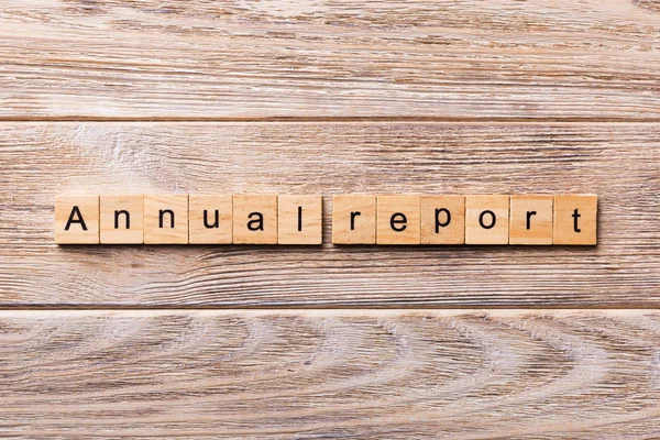 Annual report word written on wood block. Annual report text on wooden table for your desing, concept.