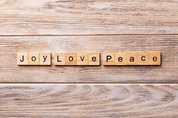 joy love peace word written on wood block. joy love peace text on wooden table for your desing, concept.