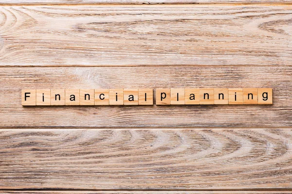 financial planning word written on wood block. financial planning text on wooden table for your desing, concept.