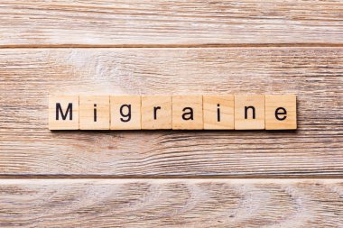 Migren sözcüğü ahşap blok üzerinde yazılı. Migren metin, tasarım, ahşap masanın kavramı.