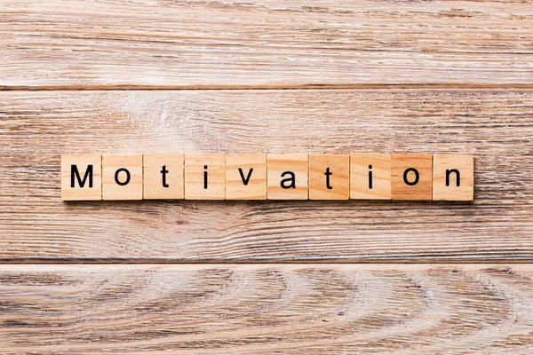 Motivation word written on wood block. Motivation text on wooden table for your desing, concept.