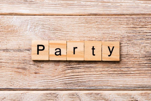 PARTY word written on wood block. PARTY text on wooden table for your desing, concept.