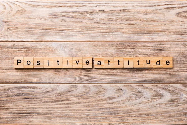 Positive Attitude word written on wood block. Positive Attitude text on wooden table for your desing, concept.
