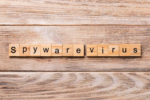 Spyware virus word written on wood block. Spyware virus text on wooden table for your desing, concept.