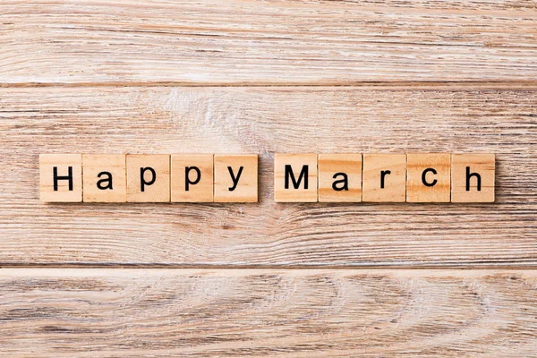 Happy March word written on wood block. Happy March text on table, concept.
