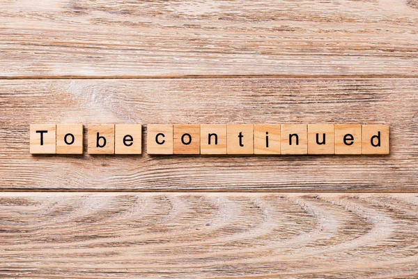 To be continued word written on wood block. To be continued text on wooden table for your desing, concept. — Stock Image Continued Word Written Wood Block Continued Text Wooden Table Your Stock Photo