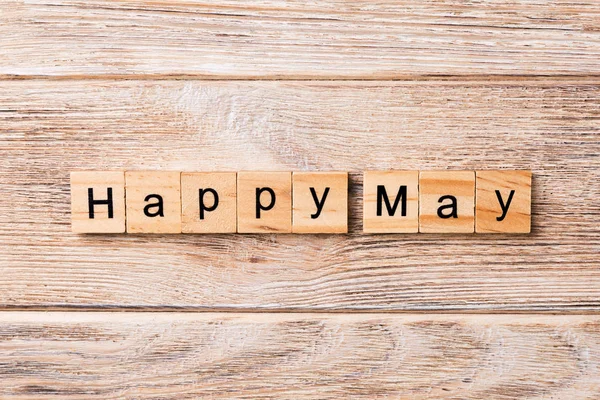 Happy May word written on wood block. Happy May text on table, concept.