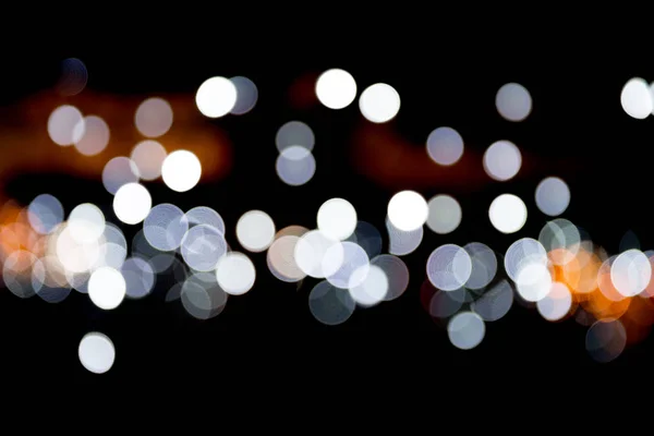 Bokeh white lights on black background, defocused and blurred many round light on background — Stock Photo, Image