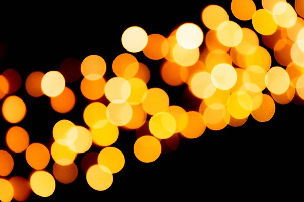 Defocused city gold night bokeh abstract background. blurred many round yellow light on dark background — Stock Photo, Image