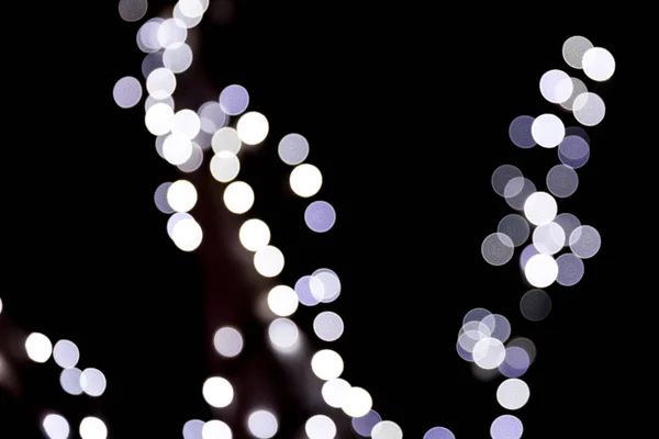 Unfocused abstract white bokeh on black background. defocused and blurred many round light — Stock Photo, Image