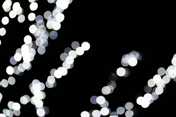 Bokeh branco abstrato sem foco no fundo preto. desfocado e desfocado muitos luz redonda — Fotografia de Stock