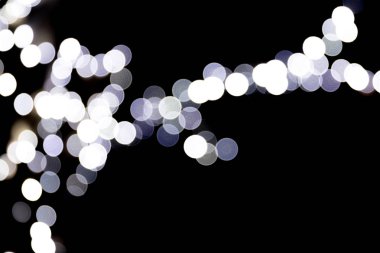 Soyut glitter siyah arka plan üzerine defocused bokeh ışıltı. birçok ışık arka plan üzerinde yuvarlak