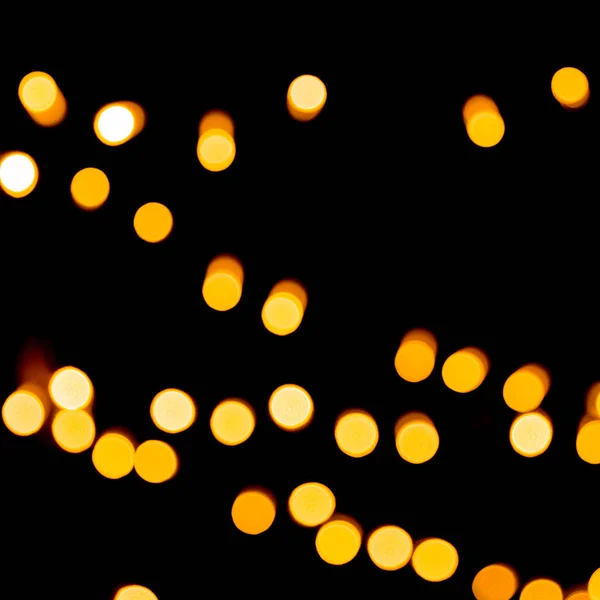 Unfocused abstract orange bokeh on black background. defocused and blurred many round light — Stock Photo, Image