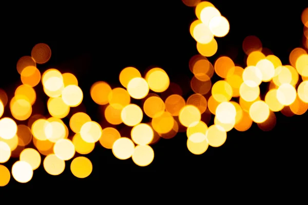 Defocused city gold night bokeh abstract background. blurred many round yellow light on dark background — Stock Photo, Image