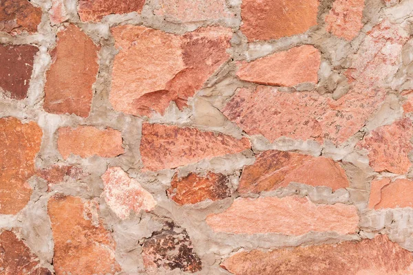 Parede de pedra vermelha ao ar livre fundo e textura de pedra de ardósia decorativa — Fotografia de Stock