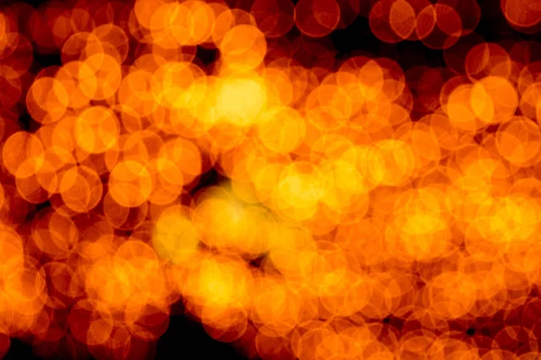 Unfocused abstract orange bokeh on black background. defocused and blurred many round light — Stock Photo, Image