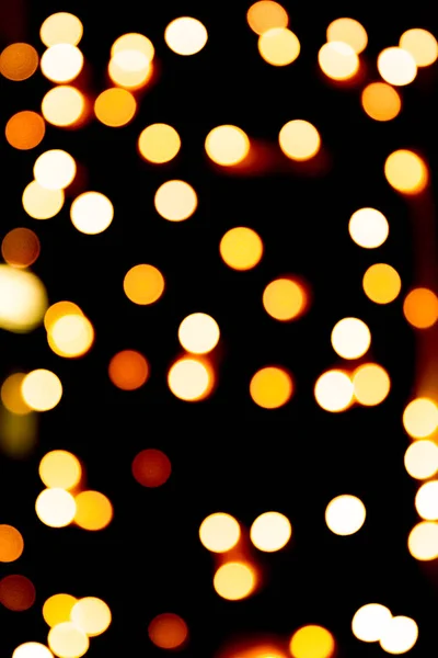 Unfocused abstract gold bokeh on black background. defocused and blurred many round light — Stock Photo, Image