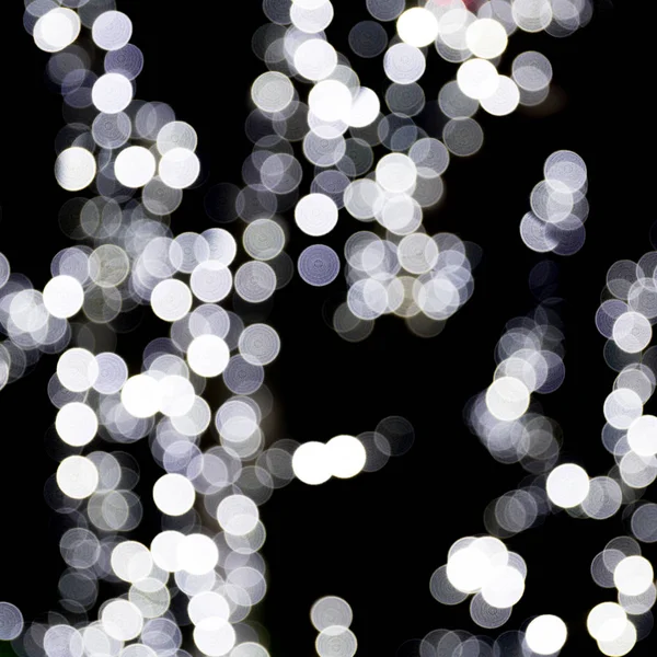 stock image Unfocused abstract white bokeh on black background. defocused and blurred many round light