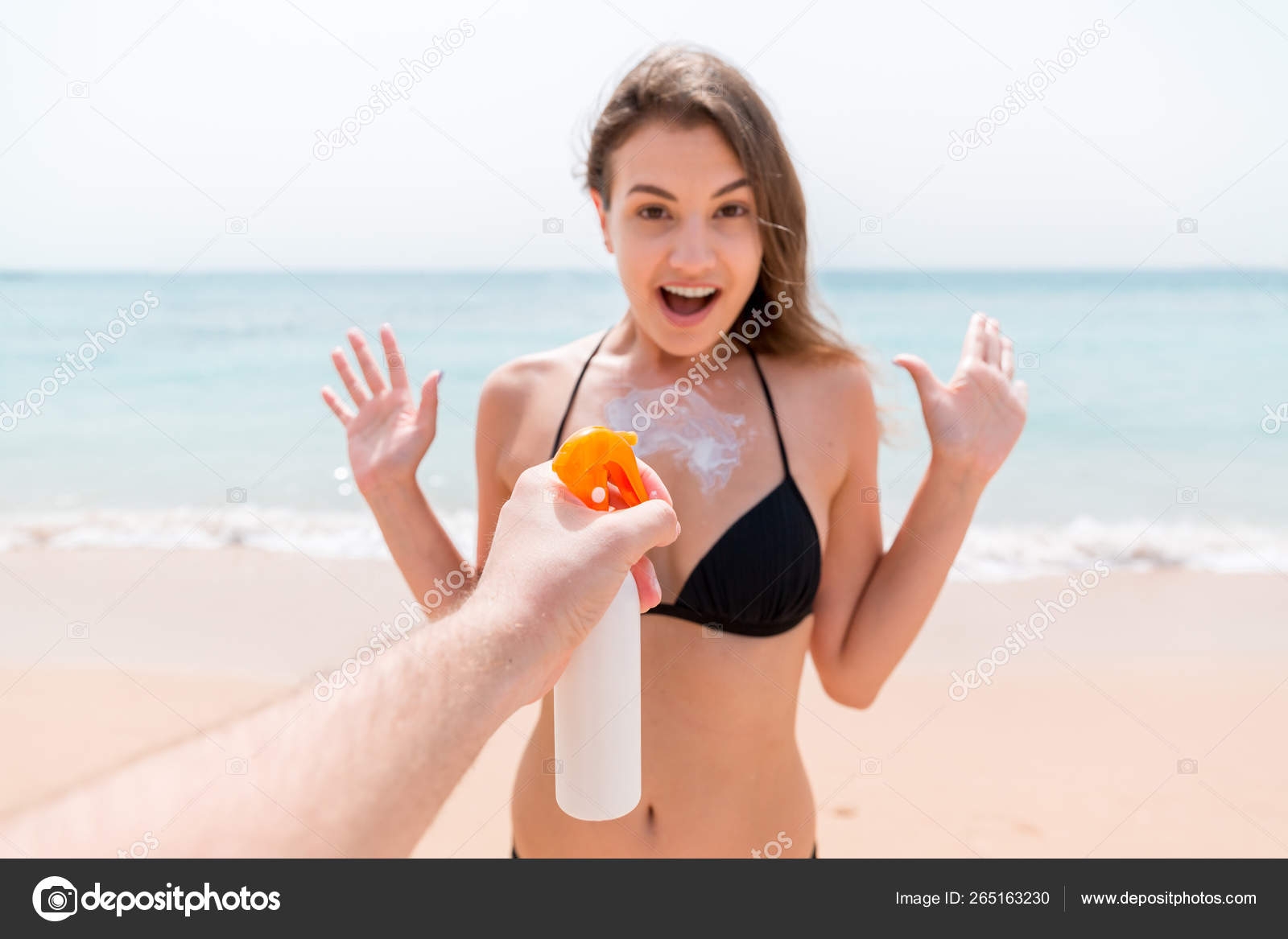 Lady in bikini tanning by pool, spraying sunscreen oil on hips stock footage