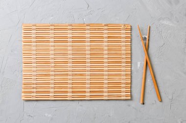 kopya stace ile taş Arka Plan Üst görünümü üzerinde boş bambu paspas veya ahşap plaka ile iki suşi çubukları