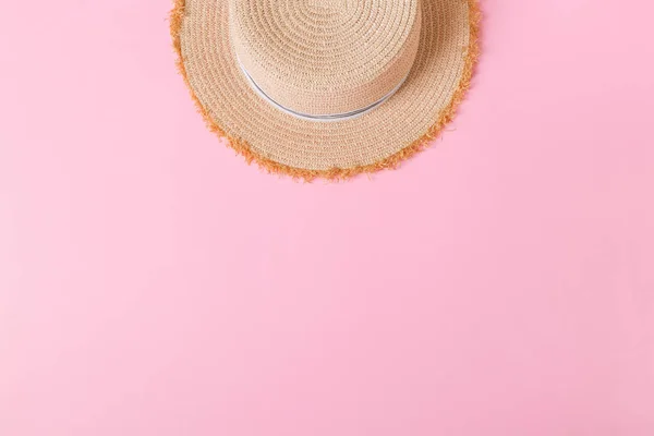 yellow retro straw hat top view with copy space. summer concept on pink background