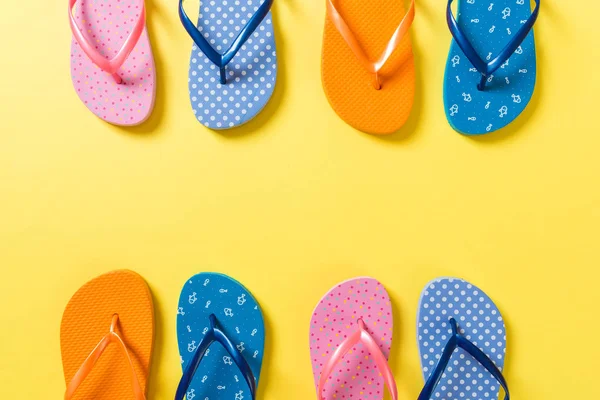 Veel flip flop gekleurde sandalen, zomer vakantie op gekleurde achtergrond, kopieer ruimte Top View — Stockfoto