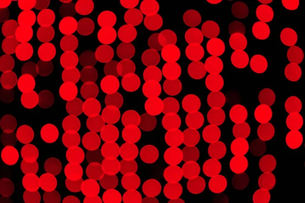 Unfocused abstract red bokeh on black background. defocused and blurred many round light — Stock Photo, Image