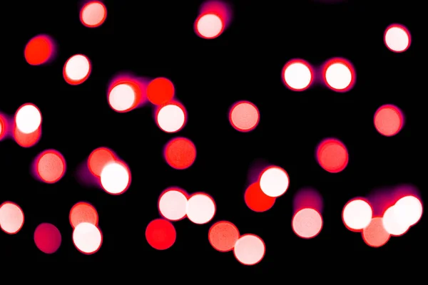 Bokeh rosso astratto sfocato su sfondo nero. sfocato e sfocato molti luce rotonda — Foto Stock