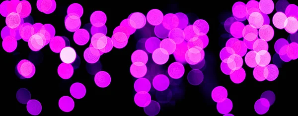 Unfocused abstract purple bokeh on black background. defocused and blurred many round light — Stock Photo, Image