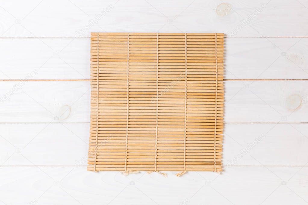 Empty Asian Food Background. brown Bamboo mat on wnite wooden background top view with copy space flat lay