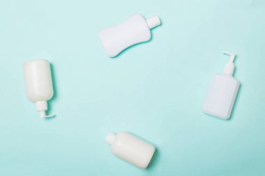Beyaz Kozmetik kapları mavi arka plan üzerinde izole seti, kopya alanı ile üst görünümü. Tasarım için boş alana sahip plastik vücut bakım şişe kapları Grubu
