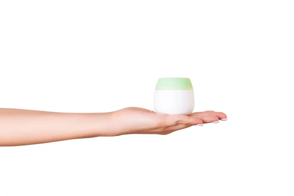Kvinnlig hand hållande grädde flaska av lotion isolerad. Flicka ge jar kosmetiska produkter på vit bakgrund — Stockfoto
