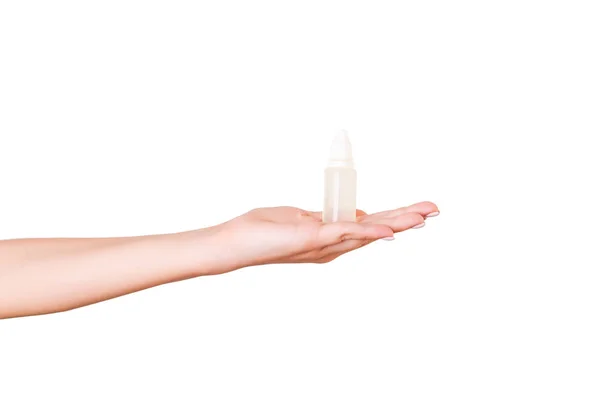 Female hand holding cream bottle of lotion isolated. Girl give tube cosmetic products on white background — Stock Photo, Image